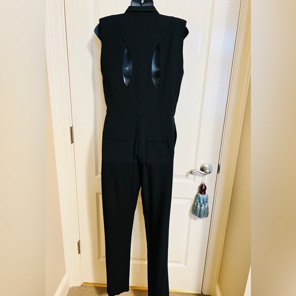 ASOS Black Jumpsuit. hidden button front. Side Pockets. Back cutouts. Size US8